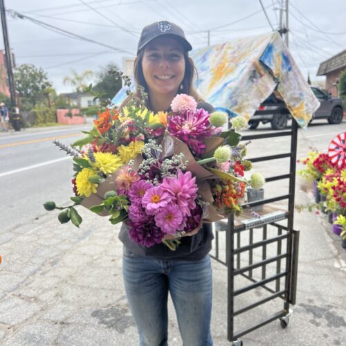 A Tomatopalooza customer scoring bunches of flowers for a wedding shower.